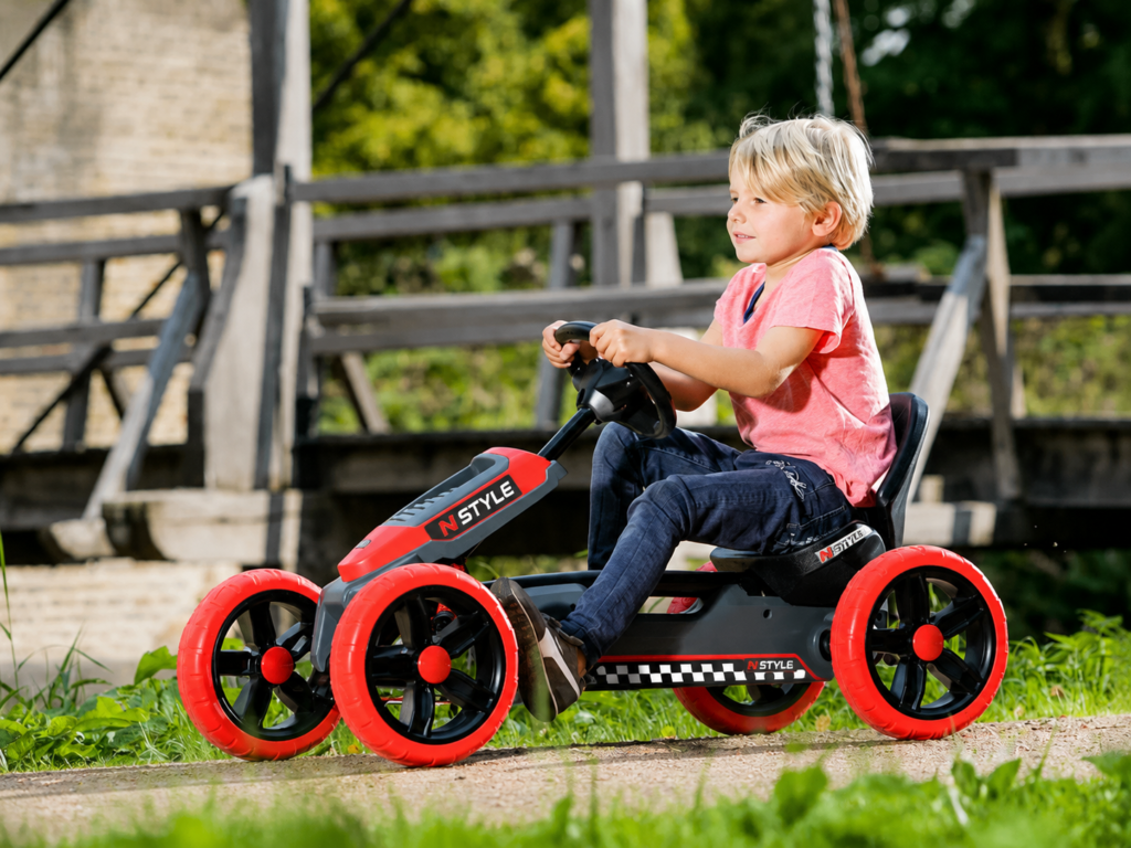 Child riding go-kart in park